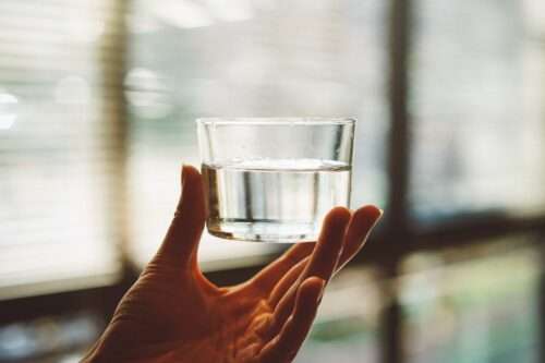 Cup of water with hand